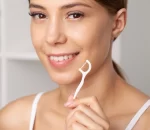 portrait-beautiful-woman-cleaning-teeth-with-dental-floss