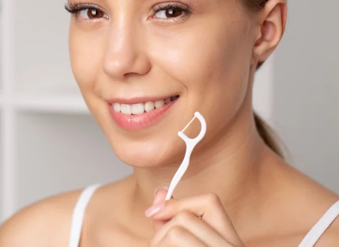 portrait-beautiful-woman-cleaning-teeth-with-dental-floss